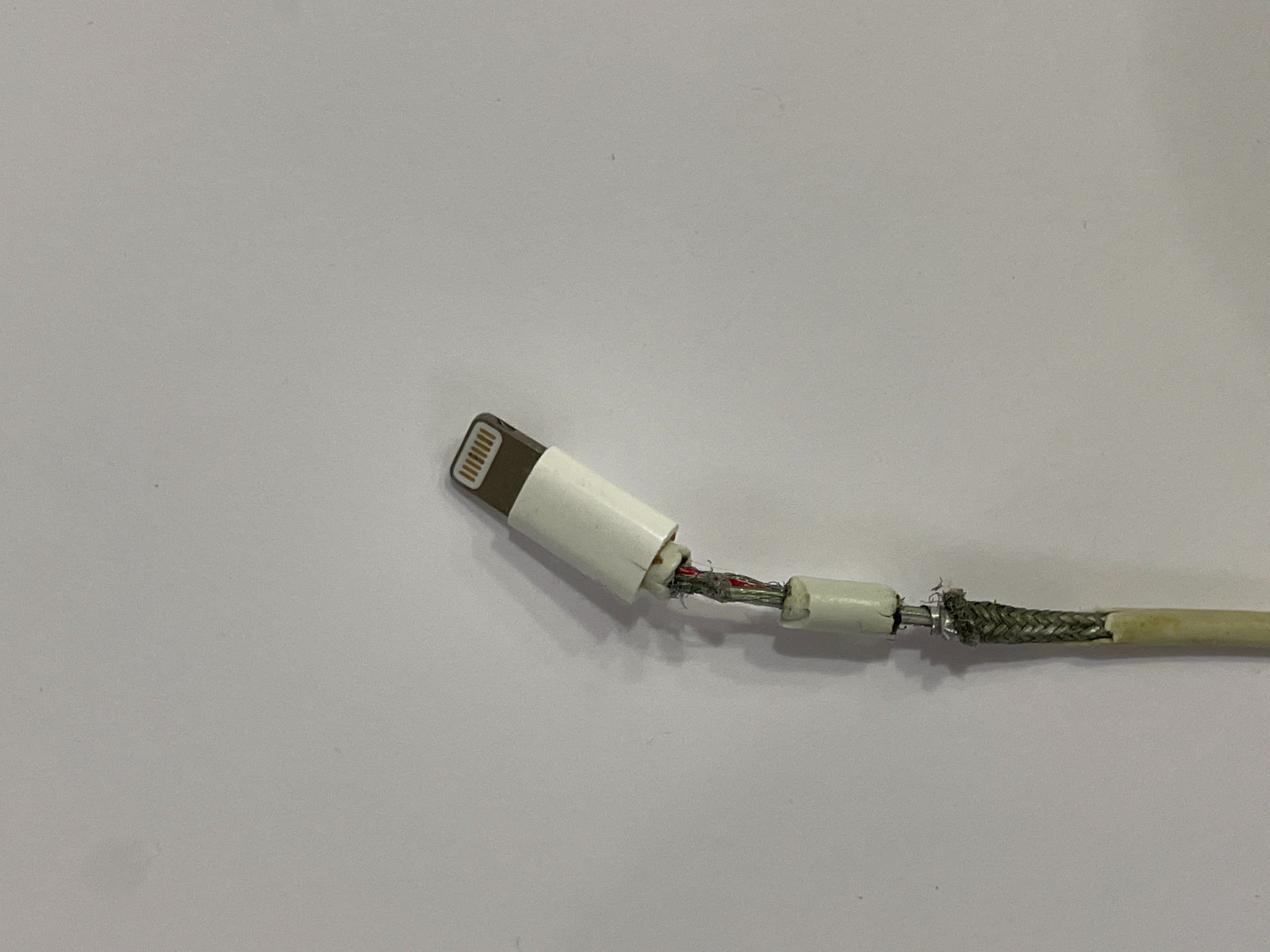 Can a torn iphone charging cable cause a fire? If i wrap electrical tape  around it is that a good fix? Or do i need to get a replacement  immediately? : r/askanelectrician